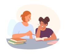 Teacher talking to high school student at desk with books